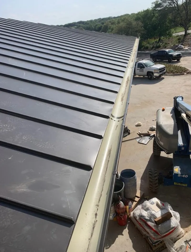 Standing seam panel and gutter detail on a metal roofing jobsite in East Bridgewater
